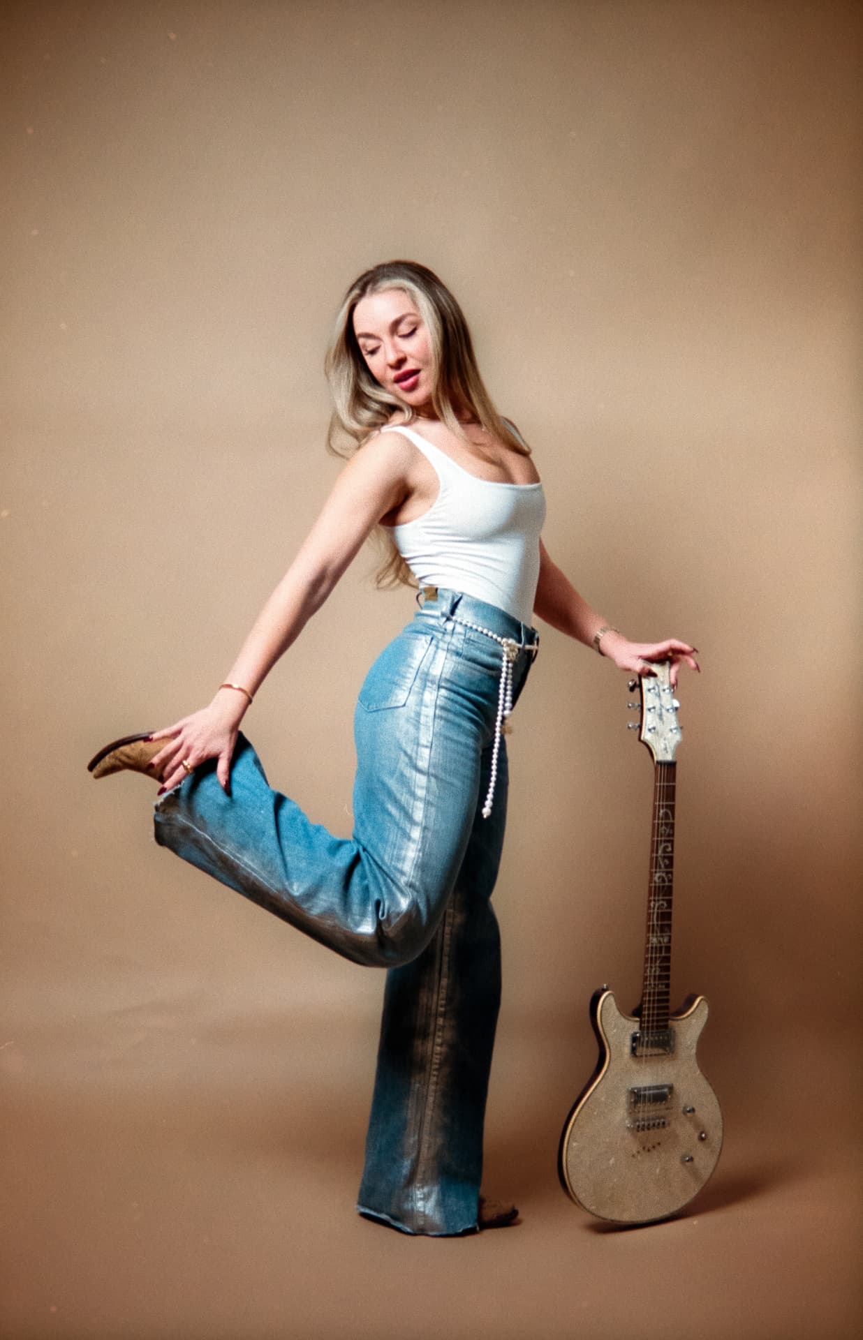 Gina De La Guardia posing with an electric guitar